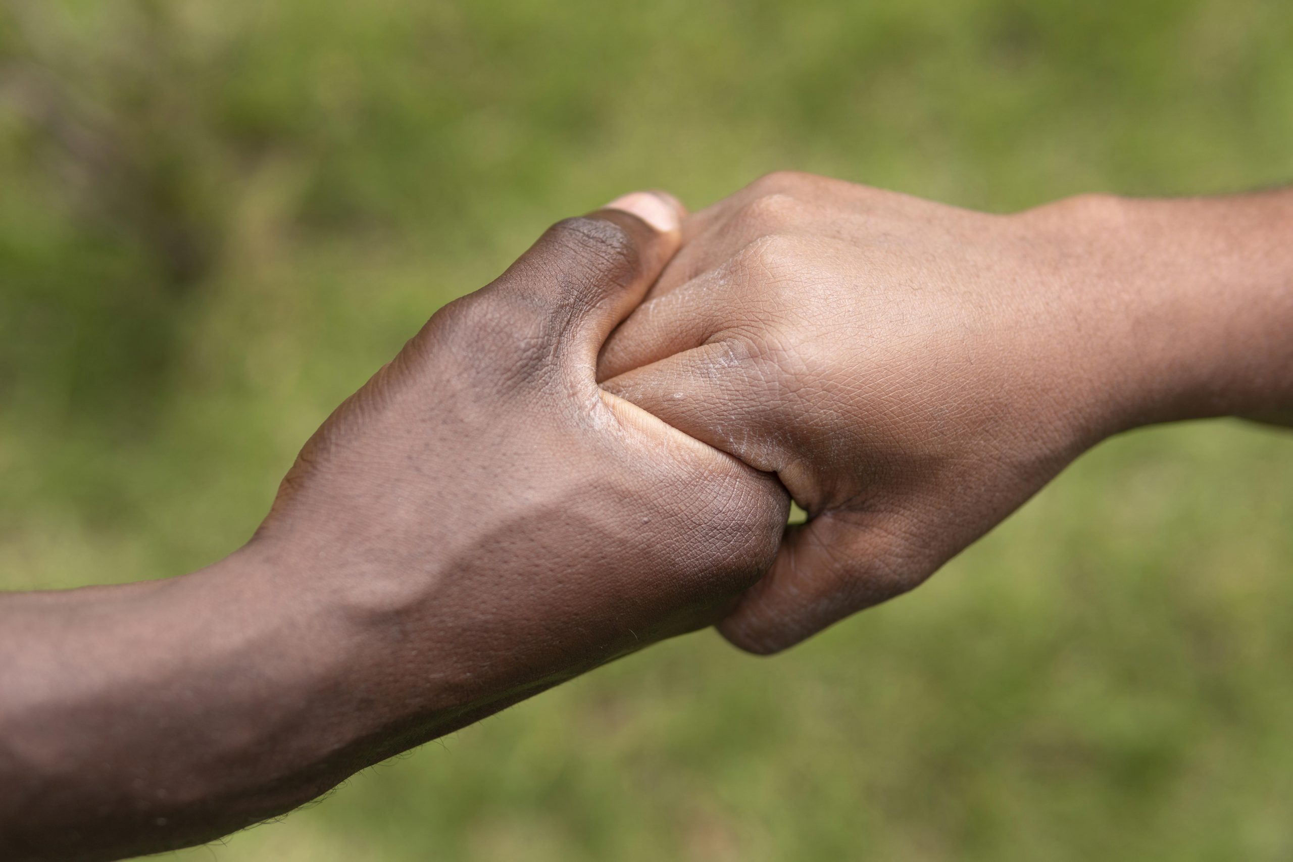 close-up-adult-hand-holding-kid-hand